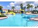 Fun community pool area featuring water slides, palm trees, and plenty of space for recreation at 2016 Lakeside Ave, Davenport, FL 33837