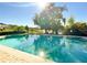 Inviting community pool with clear blue water, surrounded by lush greenery and mature trees at 2016 Lakeside Ave, Davenport, FL 33837