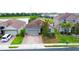 Beautiful single-Gathering home features a clay tile roof, brick driveway, and well-manicured lawn at 2016 Lakeside Ave, Davenport, FL 33837