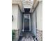 Close up shot of a welcoming black front door, flanked by stone accents, offering a glimpse of a cozy home at 2016 Lakeside Ave, Davenport, FL 33837