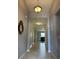 Inviting hallway with tile floors leads to the living room; pendant light at 2016 Lakeside Ave, Davenport, FL 33837