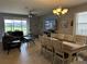 Spacious living room with tile floors, a large sectional sofa, and views of the lanai and backyard at 2016 Lakeside Ave, Davenport, FL 33837