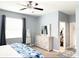 Charming main bedroom with light-blue walls, ceiling fan, a large mirror, and a walk-in closet at 2016 Lakeside Ave, Davenport, FL 33837