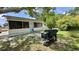 Backyard view with a grill and a peek at a portion of the screened in patio at 2127 Patrick St, Kissimmee, FL 34741