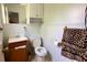 Functional bathroom with white fixtures, wood-look vanity, and neutral decor at 2127 Patrick St, Kissimmee, FL 34741