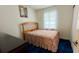 Simple bedroom with floral bedding, bedside table, and natural light at 2127 Patrick St, Kissimmee, FL 34741
