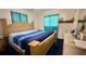 Cozy bedroom with blue accents, comfortable bed, and bedside tables at 2127 Patrick St, Kissimmee, FL 34741