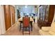 Open dining area view to the kitchen featuring tile floors and an antique china cabinet at 2127 Patrick St, Kissimmee, FL 34741