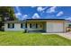 Charming single-story home featuring a well-maintained lawn, covered entry, and attached one-car garage at 2127 Patrick St, Kissimmee, FL 34741
