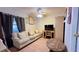Bright living room with comfortable sofa, ceiling fan, and tile flooring at 2127 Patrick St, Kissimmee, FL 34741