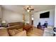 Inviting living room with ceiling fan, hard wood floors, and comfortable seating arrangement at 2127 Patrick St, Kissimmee, FL 34741