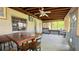 Spacious screened patio with wood ceiling, ceiling fan, and tiled flooring at 2127 Patrick St, Kissimmee, FL 34741