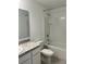 Neat bathroom with a shower-tub combo and vanity with ample lighting and modern design at 254 Mandovi St, Davenport, FL 33837