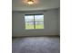 Cozy bedroom with a large window overlooking a green lawn, perfect for relaxing at 254 Mandovi St, Davenport, FL 33837