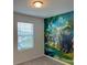 Vibrant bedroom with a jungle-themed mural, a window view, and plush carpeting at 254 Mandovi St, Davenport, FL 33837