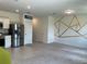 Open concept living room featuring carpet floors, white walls with geometric design, and modern decor at 254 Mandovi St, Davenport, FL 33837