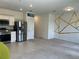 Open concept living room featuring tile and carpet floors, white walls with geometric design, and modern decor at 254 Mandovi St, Davenport, FL 33837