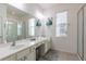 Bright bathroom features a double vanity, a large mirror, and a separate glass-enclosed shower at 2623 Calistoga Ave, Kissimmee, FL 34741