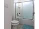 Clean bathroom featuring a tiled shower with glass doors, and a toilet at 2623 Calistoga Ave, Kissimmee, FL 34741