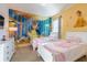 Charming bedroom with a Beauty and the Beast themed mural and two twin beds at 2623 Calistoga Ave, Kissimmee, FL 34741