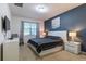 Modern bedroom features a navy blue accent wall, a white bed frame, and lots of natural light at 2623 Calistoga Ave, Kissimmee, FL 34741