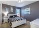 Comfortable bedroom with gray walls, stylish decor, and a queen-sized bed at 2623 Calistoga Ave, Kissimmee, FL 34741
