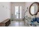 Bright foyer with a decorative mirror and console table, creating a stylish entryway at 2623 Calistoga Ave, Kissimmee, FL 34741