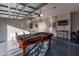 Finished garage with epoxy floors, a pool table, television, and wall art; the garage door is open at 2623 Calistoga Ave, Kissimmee, FL 34741