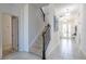 Hallway with a stairway, tile floors, and white walls leads to other areas of the house at 2623 Calistoga Ave, Kissimmee, FL 34741