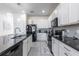 Modern kitchen with granite countertops, stainless steel appliances, and a functional layout at 2623 Calistoga Ave, Kissimmee, FL 34741