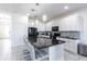 Elegant kitchen with granite countertops, white cabinets, and modern appliances, ideal for cooking at 2623 Calistoga Ave, Kissimmee, FL 34741