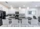 Modern kitchen with stainless steel appliances, a dark stone island, and white cabinetry provides ample storage at 2623 Calistoga Ave, Kissimmee, FL 34741