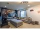 Cozy living room with a large sectional sofa, ottoman, and movie themed wall art at 2623 Calistoga Ave, Kissimmee, FL 34741