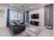 Modern living room features a gray and white color scheme, a large sofa, and sliding doors to the patio at 2623 Calistoga Ave, Kissimmee, FL 34741