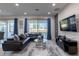Comfortable living room with a large sofa, stylish rug, and sliding glass doors for natural light at 2623 Calistoga Ave, Kissimmee, FL 34741