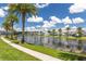 Scenic view of the community pond surrounded by lush landscaping and beautiful homes at 2623 Calistoga Ave, Kissimmee, FL 34741