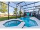 Lanai enclosed in screen with a pool and jacuzzi, and a grassy backyard at 2623 Calistoga Ave, Kissimmee, FL 34741