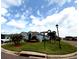 Landscaped corner lot property with vibrant green lawn, and mature palm trees at 2919 Woodward Ln, Winter Haven, FL 33884