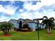 Corner lot home with manicured front yard, decorative shrubs and palm trees at 2919 Woodward Ln, Winter Haven, FL 33884