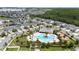 Community aerial view with a large community pool and playground amid homes and lush landscaping at 3052 Prelude Ln, Kissimmee, FL 34746