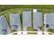 Aerial view of gray-roofed homes, showcasing well-kept lawns, paver driveways, and a neatly arranged neighborhood at 3052 Prelude Ln, Kissimmee, FL 34746