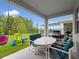 Covered back porch with outdoor seating, a grill, and a view of the fenced backyard and playground set at 3052 Prelude Ln, Kissimmee, FL 34746