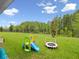 Spacious backyard with a slide and mini-trampoline offering a great play area for children in a fenced yard at 3052 Prelude Ln, Kissimmee, FL 34746
