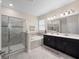 Bright bathroom features a double vanity, large mirror, and a glass-enclosed shower at 3052 Prelude Ln, Kissimmee, FL 34746