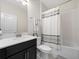 Clean bathroom featuring a shower-tub combo with stylish curtain and modern vanity at 3052 Prelude Ln, Kissimmee, FL 34746