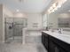 Bathroom with double vanity, soaking tub, and a glass-enclosed shower at 3052 Prelude Ln, Kissimmee, FL 34746