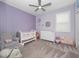 Cozy bedroom with lavender walls, plush carpet, and ample natural light at 3052 Prelude Ln, Kissimmee, FL 34746