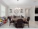 Dining room featuring a round wood table, chandelier, and built-in shelving with decorative items at 3052 Prelude Ln, Kissimmee, FL 34746