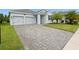 Charming single-story home with a two-car garage, paver driveway, and manicured lawn at 3052 Prelude Ln, Kissimmee, FL 34746