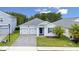 Charming single-story home featuring a two-car garage, paver driveway, and well-maintained landscaping at 3052 Prelude Ln, Kissimmee, FL 34746